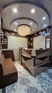 a lobby with a chandelier and a reception desk at Hotel Suraj in Raxaul