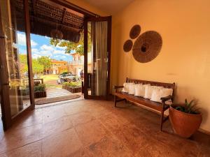 a living room with a bench with pillows on it at Pousada Jeri Dunas in Jericoacoara