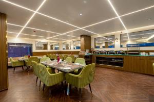a dining room with a table and chairs at The Lohias Premium - Delhi IGI Airport in New Delhi