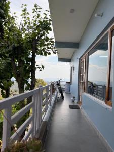 a view from the balcony of a house at Terra Himalayan Homestay in Kasar Devi in Hawālbāgh +12 photos