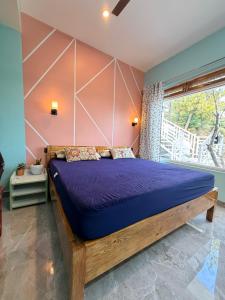 a bedroom with a large bed with purple sheets at Terra Himalayan Homestay in Kasar Devi in Hawālbāgh