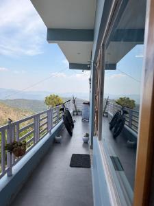 a balcony with bikes parked on the side of a building at Terra Himalayan Homestay in Kasar Devi in Hawālbāgh