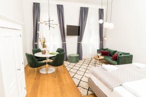 a living room with a bed and a table and chairs at MINTNaschmarkt in Vienna