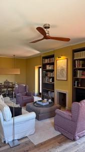 a living room with purple furniture and a fireplace at Tenuta San Filippo in Montalcino