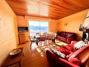 a living room with a couch and a table at T3 hypercenter with fireplace, mountain view in Font-Romeu