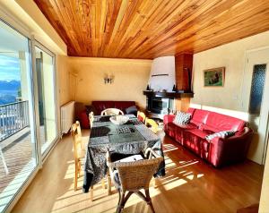 a living room with a table and a couch at T3 hypercenter with fireplace, mountain view in Font-Romeu