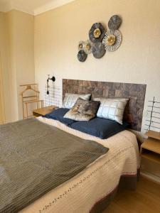 a bedroom with a large bed with a fan on the wall at T3 hypercenter with fireplace, mountain view in Font-Romeu