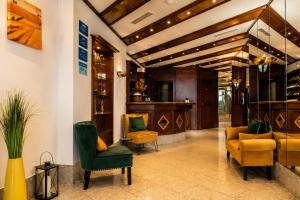 a lobby with yellow and green chairs at CityHotel Feuerbach in Stuttgart