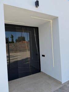 a glass door in a building with a window at Villa Paraíso in Seville