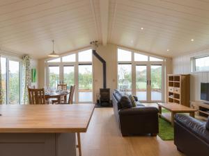 a living room with a couch and a table at Cedar Lodge in Hassocks