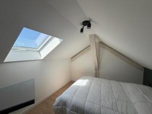 a bedroom with a bed and a large window at Duplex moderne hyper-centre Tout à pied in Thonon-les-Bains