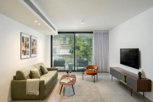 a living room with a couch and a tv at master Shenkin in Tel Aviv