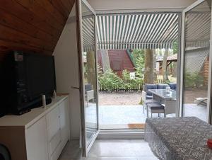 a bedroom with a sliding glass door to a patio at Brda Hideaway in Głębokie