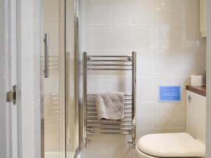 a bathroom with a toilet and a glass shower at Eldin Hall Cottage 2 - Uk2484 in Scarborough