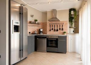 a kitchen with a stainless steel refrigerator and appliances at Villa Motti Quadri in Arona