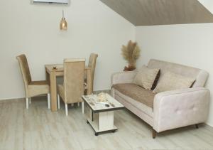 a living room with a couch and a table at Apartmani Romansa in Irig