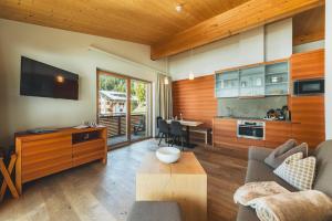 a living room with a couch and a table at Mats Lech Alpenquartier in Lech am Arlberg