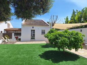 a house with a yard with a green lawn at Ca Na Luisa-Residential Area in Palmanova