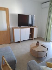 a living room with a tv and a table at Apartment Kazela in Split