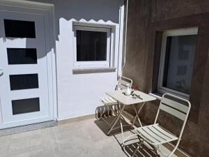 two chairs and a table in front of a door at Apartment Kazela in Split