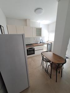 a small kitchen with a table and a table and chair at Apartment Kazela in Split +4 photos