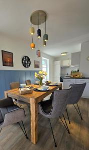 a dining room table and chairs in a kitchen at Meiereikoppel 11 in Petersdorf auf Fehmarn +36 photos