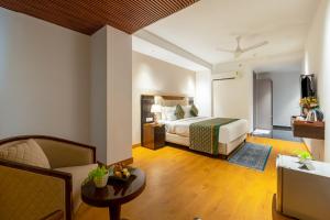a hotel room with a bed and a couch at The Lohias Premium - Delhi IGI Airport in New Delhi