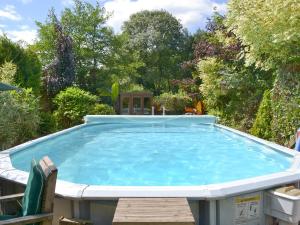 a large pool with a table and chairs in a yard at Demelza in Launceston