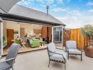 a patio with chairs and a living room at Uk47692 - Wiggles Cottage in Wimbish