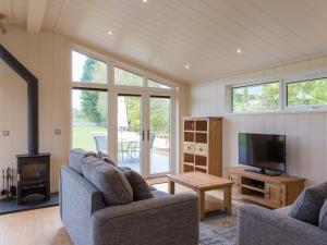 a living room with two couches and a television at Maple Lodge in Hassocks