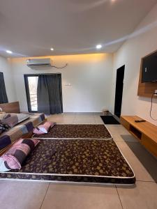a living room with a large rug on the floor at Chandan resort in Chitrāwal