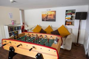 a living room with a foosball table at Callander Hostel in Callander