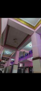 a room with pink and purple walls and ceilings at Hotel Neelkamal Guest House in Rewa