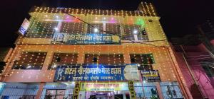 a building with christmas lights on top of it at Hotel Neelkamal Guest House in Rewa