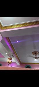 a room with a ceiling with purple lights on it at Hotel Neelkamal Guest House in Rewa