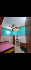 a room with a bed and a ceiling fan at Hotel Neelkamal Guest House in Rewa