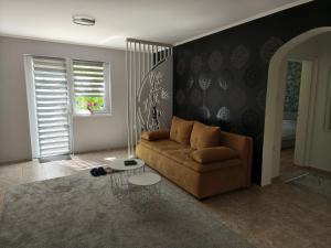 a living room with a couch and a table at Silver Spa Apartment in Bačka Palanka