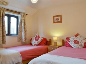 a bedroom with two beds and a window at Ross in Launceston