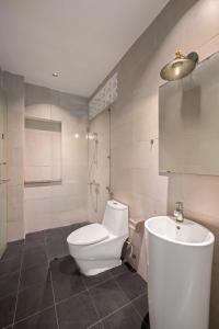 a bathroom with a toilet and a shower and a sink at Doris Entire House Da Nang in Danang