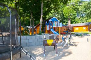 a park with a playground with a dog on a swing at Ferienwohnung Familie Täubert in Klein Uhyst