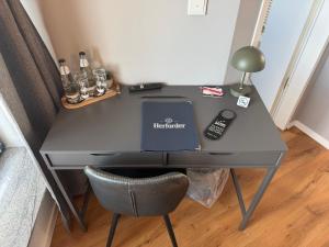 a desk with a laptop on it with a chair at Truck Inn in Bünde