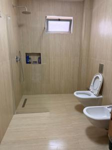 a bathroom with a toilet and a sink at Maya's home Tirana in Tirana