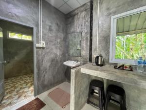 a bathroom with a sink and a shower at Baan Suan Tondin in Ban Du Son +16 photos