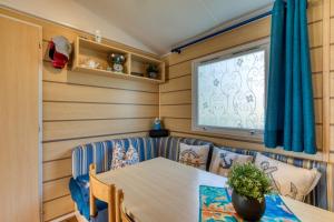 a dining room with a table and chairs at Location Mobilhome Agde in Agde