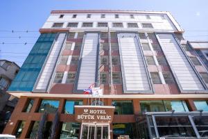 a building with a sign in front of it at Buyuk Velic Hotel in Gaziantep