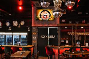 a restaurant with tables and chairs and clocks on the wall at Hotel Bosna Banja Luka in Banja Luka