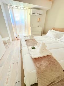 a bedroom with two beds with towels on them at M&S Home in Agrigento