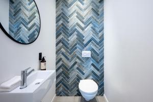 a bathroom with a white toilet and a mirror at master Shenkin in Tel Aviv +54 photos
