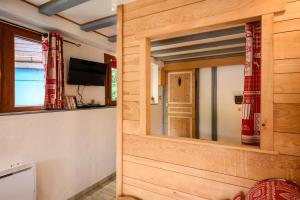 a wooden room with a mirror and a tv at Gîte La Petite Maison Des Vacances in Kaysersberg