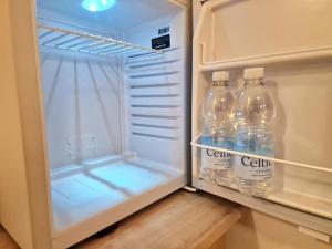 two bottles of water sitting inside of an open refrigerator at The Granby Rooms Easington East Yorkshire in Easington